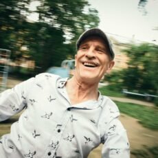an-elderly-man-laughs-as-he-spins-on-a-children-s-2025-03-08-13-02-42-utc an-elderly-man-laughs-as-he-spins-on-a-children-s-2025-03-08-13-02-42-utc