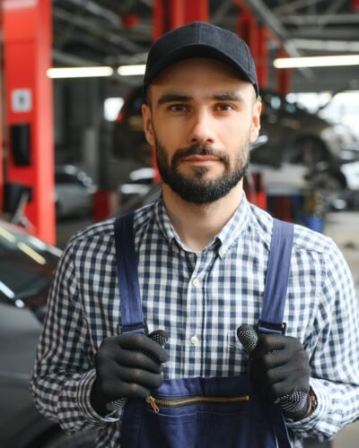Professional car mechanic working in auto repair service